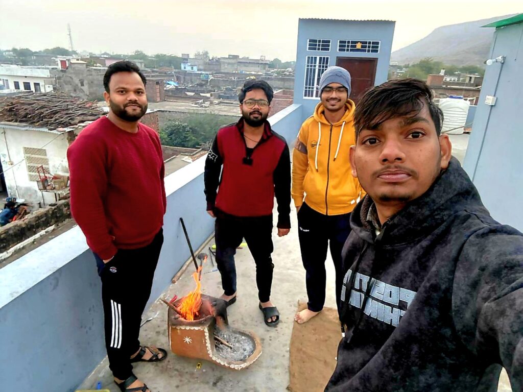 Friends, a village morning, and warmth from a small fire.